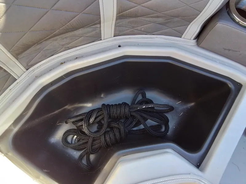 Slide: The Image of Black rope in storage compartment of 2021 Bennington Marine 24 LXSR boat. - 26