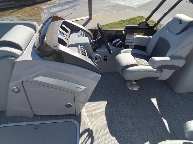 Slide: The Image of 2021 Bennington Marine 24 LXSR boat interior with captain's chair and control panel. - 28