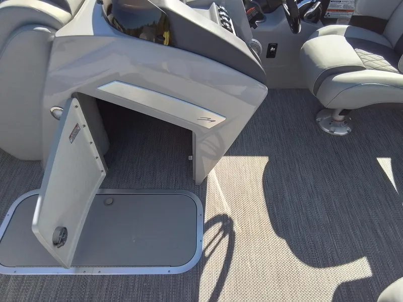 Slide: The Image of 2021 Bennington Marine 24 LXSR boat interior with open storage compartment and seating. - 29