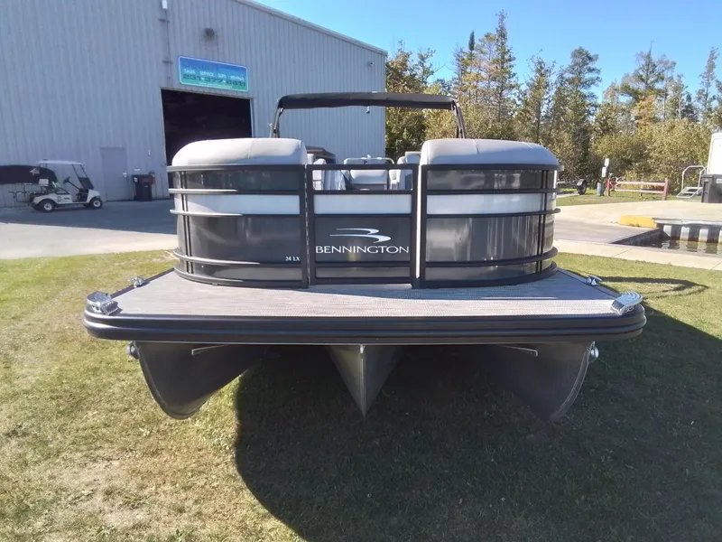 Slide: The Image of 2021 Bennington Marine 24 LXSR pontoon boat on grass near a warehouse. - 3