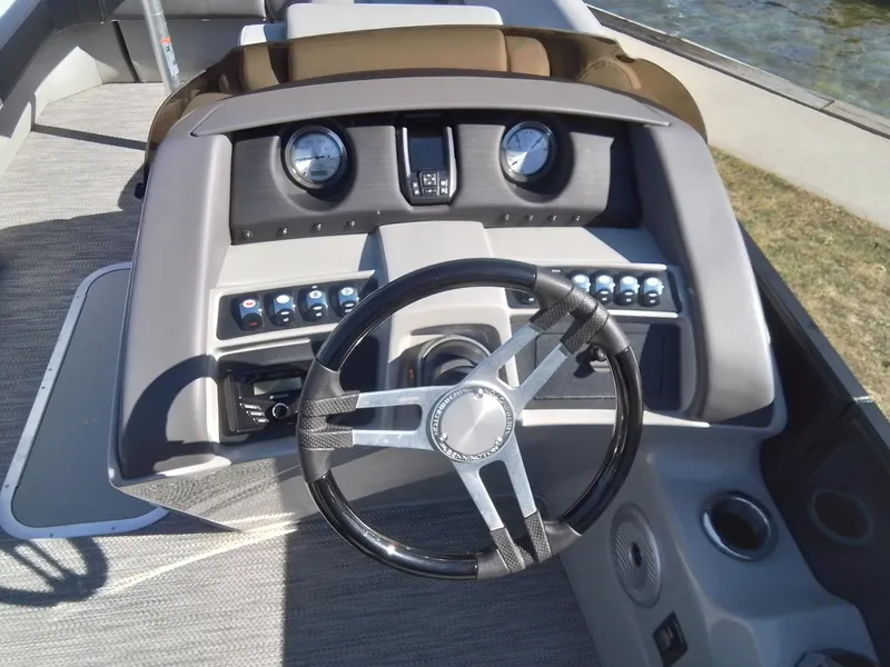 Slide: The Image of 2021 Bennington Marine 24 LXSR boat dashboard with steering wheel and controls. - 31