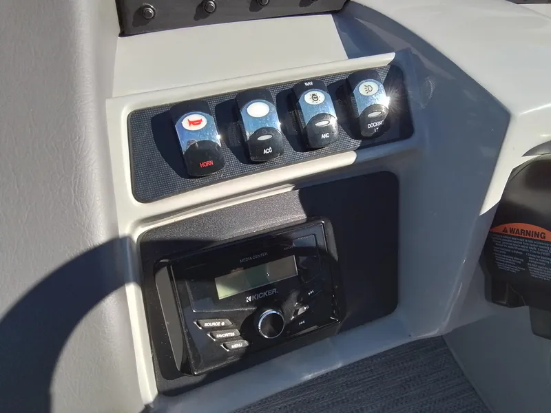 Slide: The Image of 2021 Bennington Marine 24 LXSR boat dashboard with control switches and Kicker media center. - 33