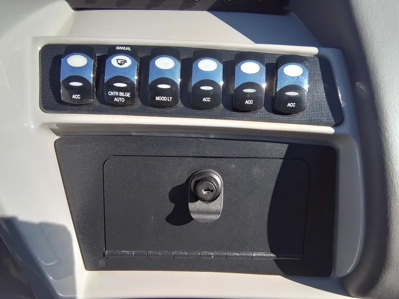 Slide: The Image of Control panel of 2021 Bennington Marine 24 LXSR boat with switches and lock. - 34