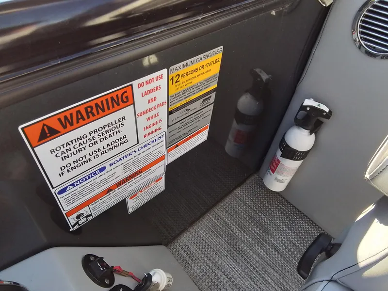 Slide: The Image of Warning labels and fire extinguisher on 2021 Bennington Marine 24 LXSR boat interior. - 37
