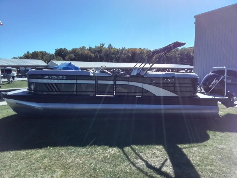 Slide: The Image of 2021 Bennington Marine 24 LXSR pontoon boat on grass, side view. - 5