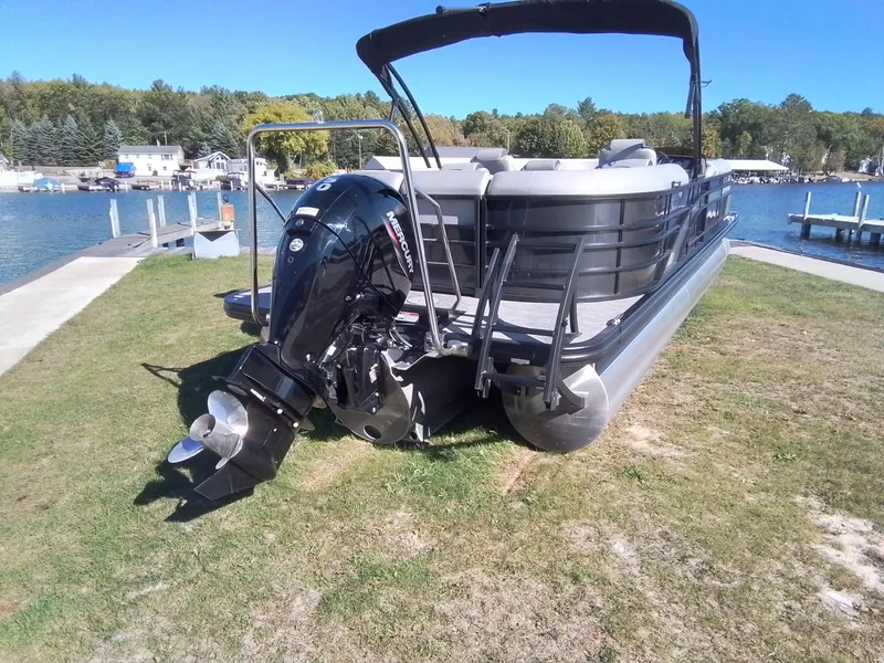 Slide: The Image of 2021 Bennington Marine 24 LXSR pontoon boat on grassy shore by a lake. - 7