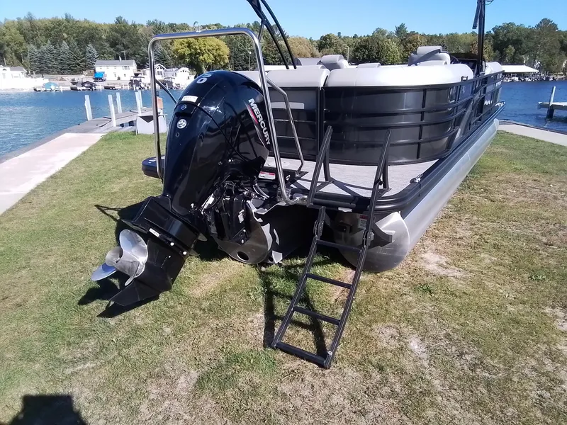 Slide: The Image of 2021 Bennington Marine 24 LXSR pontoon boat with Mercury outboard motor by a lakeside dock. - 8