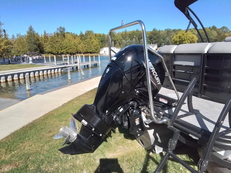 Slide: The Image of 2021 Bennington Marine 24 LXSR pontoon boat with Mercury outboard motor by a lakeside dock. - 9