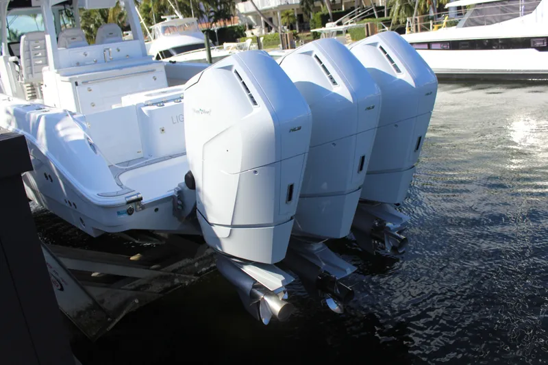 Slide: The Image of Three outboard engines on a 2023 HCB 42 Lujo boat. - 16