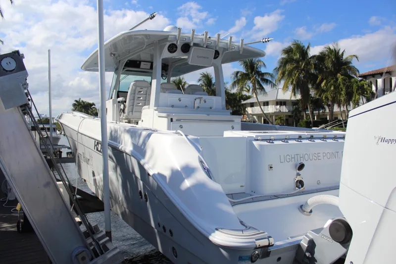 Slide: The Image of 2023 HCB 42 Lujo boat docked with palm trees in background. - 35