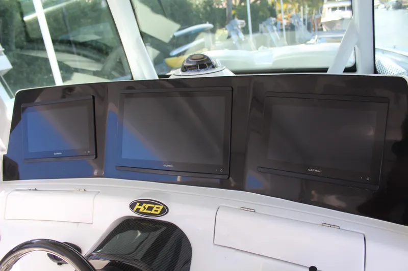 Slide: The Image of Dashboard of HCB 42 Lujo 2023 with three screens. - 7