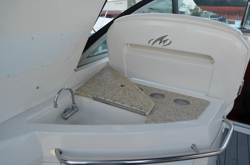 Slide: The Image of 2009 Monterey 320 Sport Yacht sink and countertop with faucet and storage space. - 13