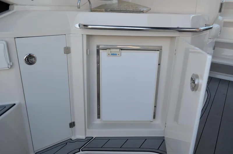 Slide: The Image of 2009 Monterey 320 Sport Yacht interior with open cabinet and mini fridge. - 14