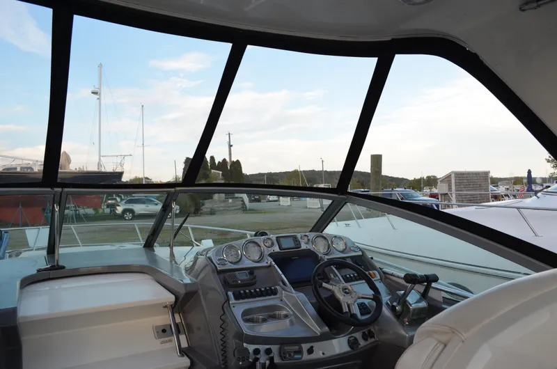 Slide: The Image of 2009 Monterey 320 Sport Yacht cockpit with steering wheel and dashboard, docked at marina. - 16