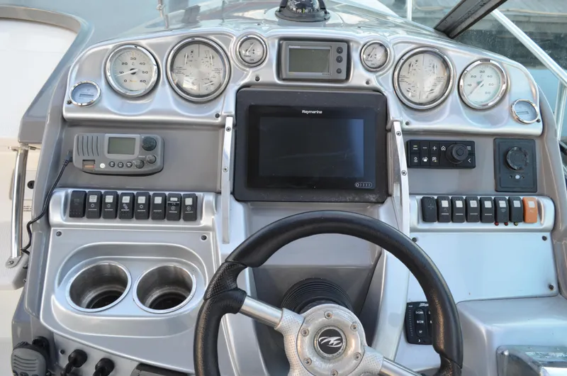 Slide: The Image of Control panel of a 2009 Monterey 320 Sport Yacht with gauges and navigation equipment. - 18