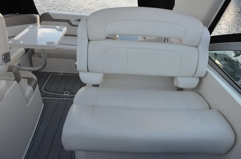 Slide: The Image of 2009 Monterey 320 Sport Yacht interior with white seating and table. - 19