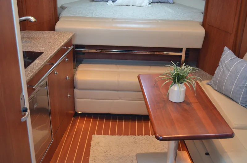 Slide: The Image of Interior of 2009 Monterey 320 Sport Yacht with kitchenette, seating, and table. - 22