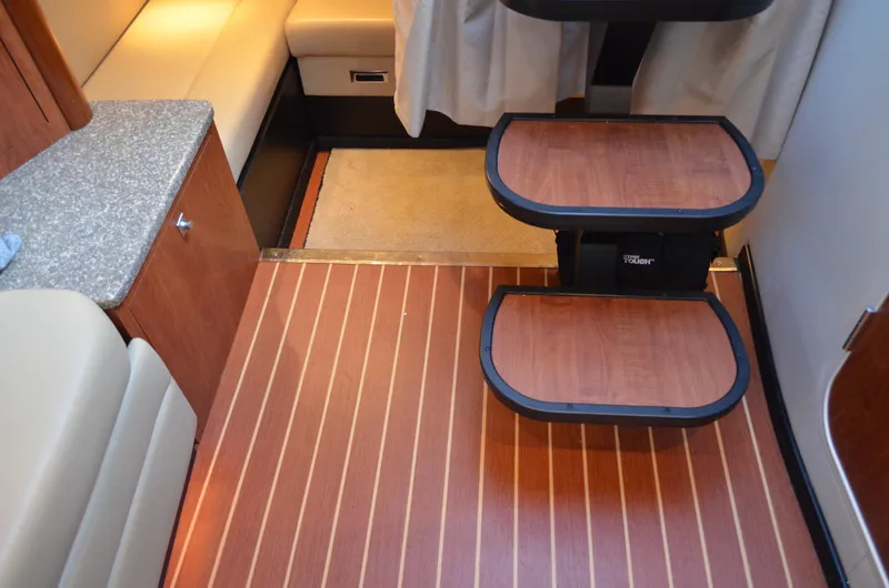 Slide: The Image of Interior of 2009 Monterey 320 Sport Yacht with wooden steps and seating area. - 23