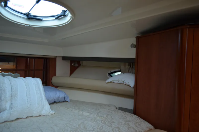 Slide: The Image of Interior cabin of 2009 Monterey 320 Sport Yacht with bed and porthole. - 27