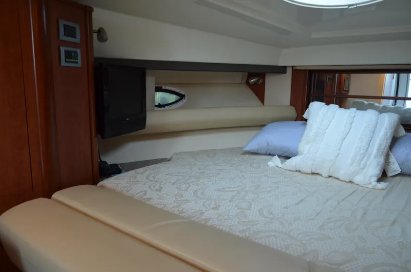 Slide: The Image of Luxurious cabin interior of 2009 Monterey 320 Sport Yacht with cozy bedding and TV. - 28