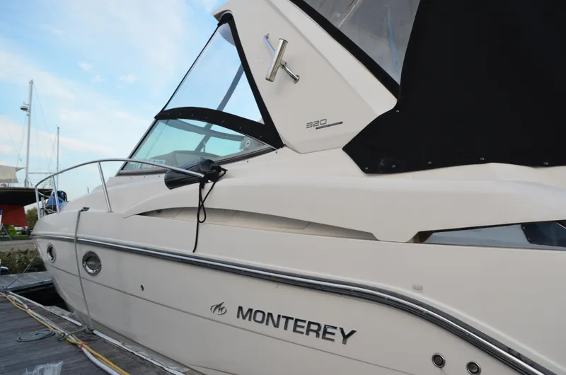 Slide: The Image of 2009 Monterey 320 Sport Yacht docked, showcasing sleek design and modern features. - 3