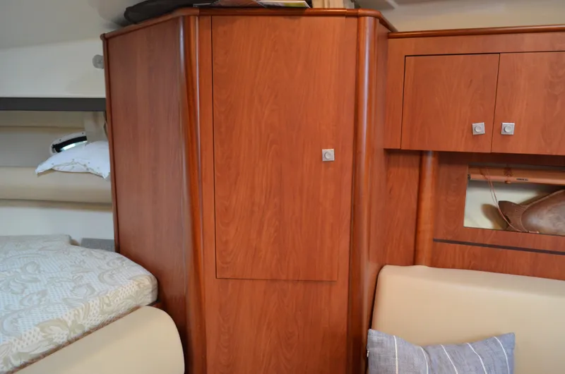 Slide: The Image of Interior of 2009 Monterey 320 Sport Yacht with wooden cabinetry and cozy bedding. - 31
