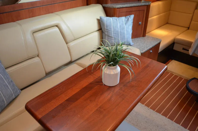 Slide: The Image of Interior of 2009 Monterey 320 Sport Yacht with wooden table and potted plant. - 34