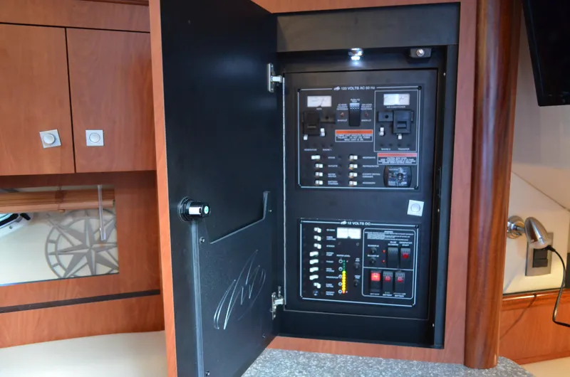 Slide: The Image of Electrical panel inside 2009 Monterey 320 Sport Yacht, featuring switches and controls. - 36