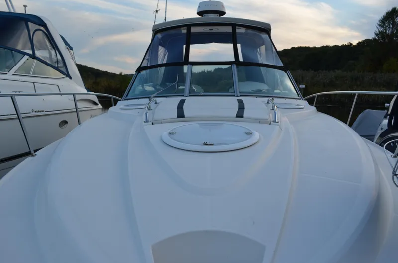 Slide: The Image of 2009 Monterey 320 Sport Yacht docked, showcasing sleek design and spacious deck. - 4