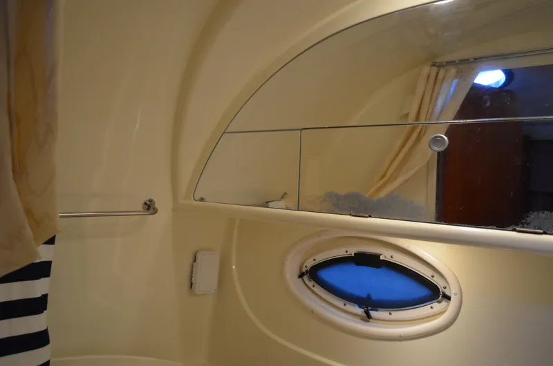 Slide: The Image of Interior of 2009 Monterey 320 Sport Yacht bathroom with porthole and shower curtain. - 42