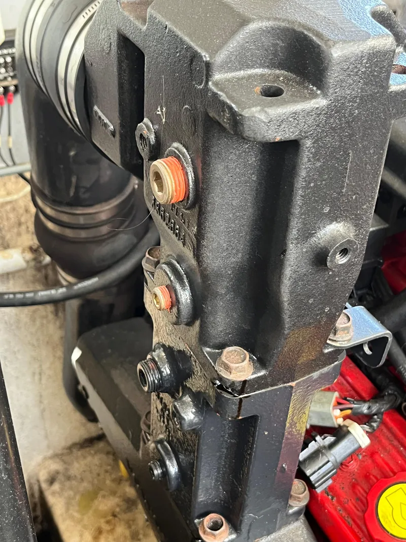 Slide: The Image of Close-up of a 2009 Monterey 320 Sport Yacht engine component with visible bolts and connectors. - 48