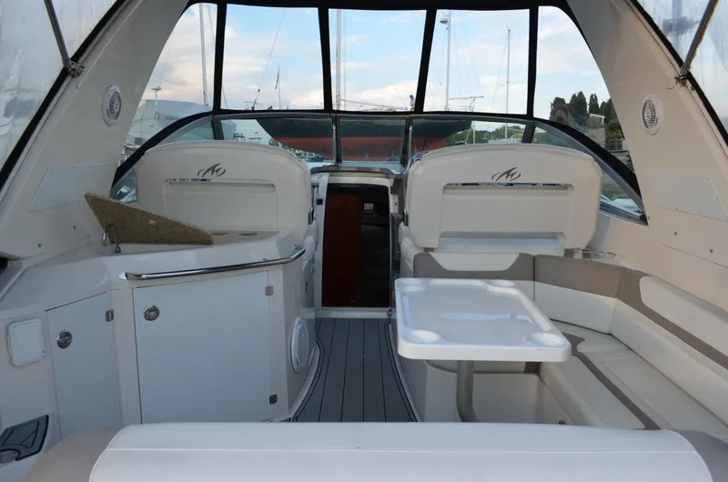 Slide: The Image of 2009 Monterey 320 Sport Yacht interior with seating and table, showcasing luxury and comfort. - 8