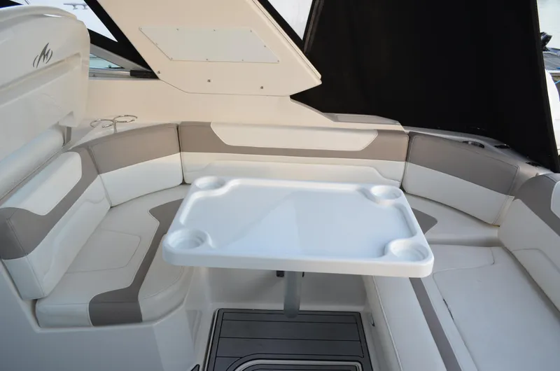 Slide: The Image of 2009 Monterey 320 Sport Yacht interior with cushioned seating and table. - 9