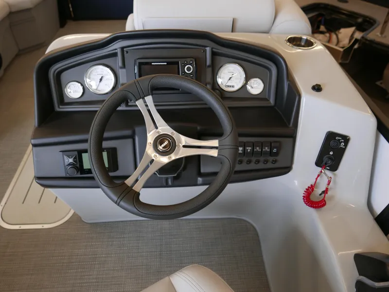 Slide: The Image of 2025 Bentley Pontoons Legacy 223 Navigator dashboard with steering wheel and gauges. - 10