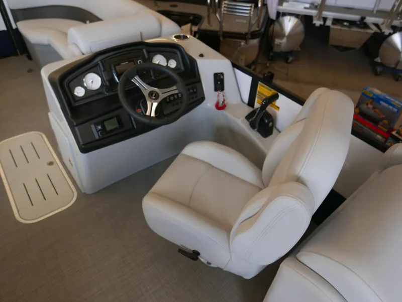 Slide: The Image of 2025 Bentley Pontoons Legacy 223 Navigator interior with steering console and plush seating. - 9