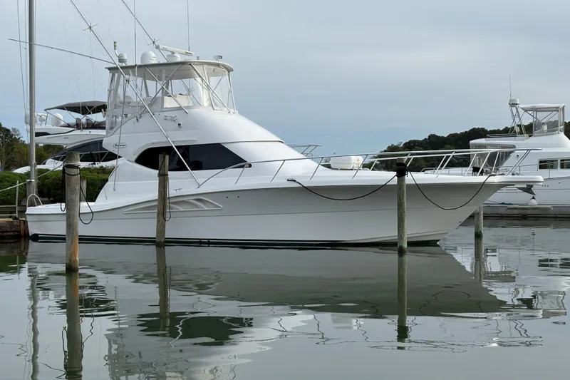 The Image of 2003 Rampage 45 Convertible yacht docked in calm marina waters. - 0