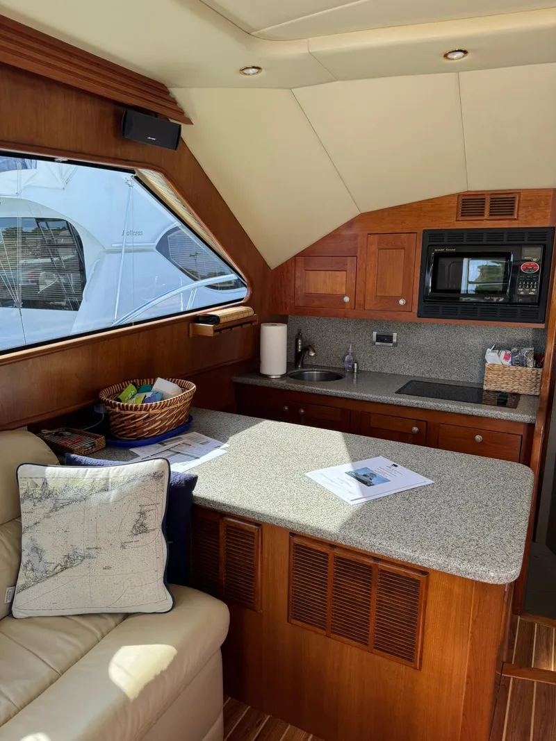 Slide: The Image of Interior of 2003 Rampage 45 Convertible yacht with kitchen and seating area. - 10