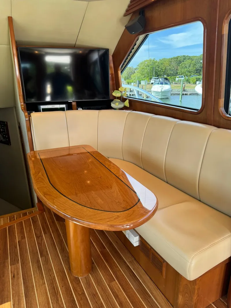 Slide: The Image of Luxurious interior of 2003 Rampage 45 Convertible yacht with leather seating and wooden table. - 11
