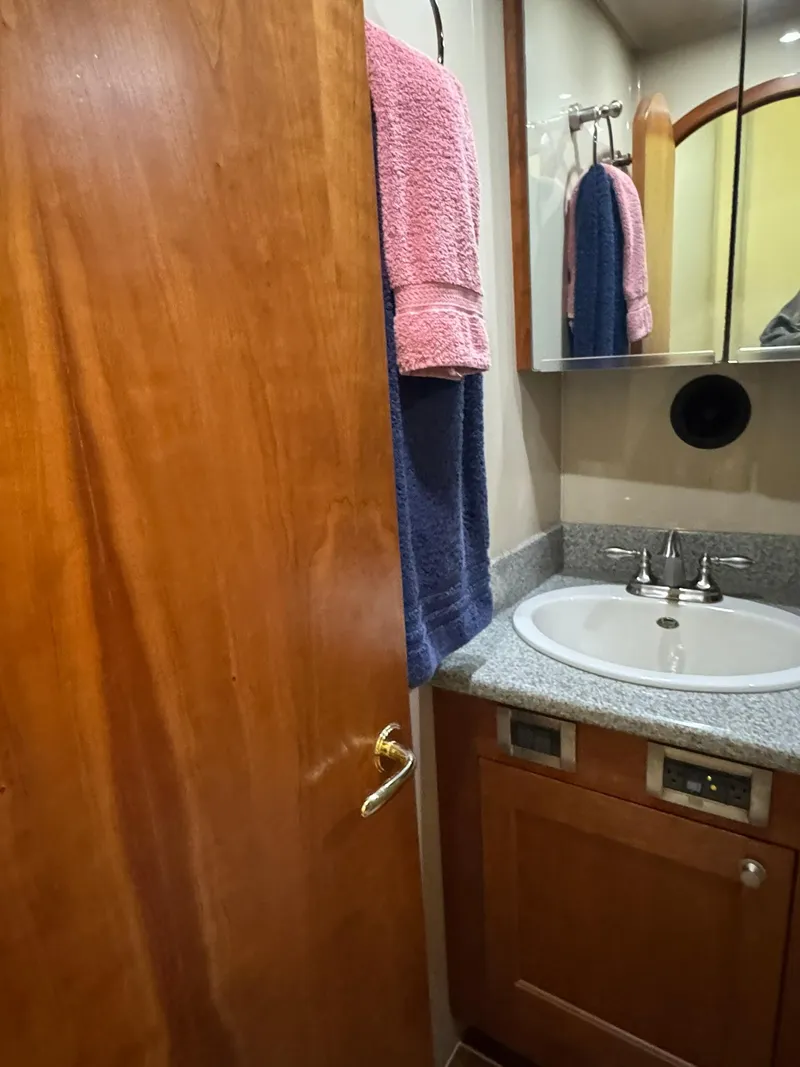 Slide: The Image of 2003 Rampage 45 Convertible bathroom with wooden door, sink, and towels. - 18