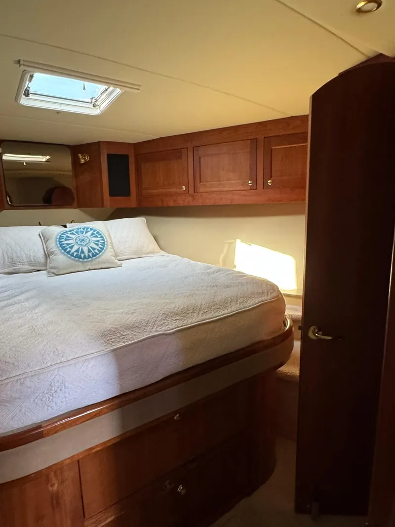 Slide: The Image of Luxurious bedroom interior of 2003 Rampage 45 Convertible yacht with wooden cabinetry. - 22