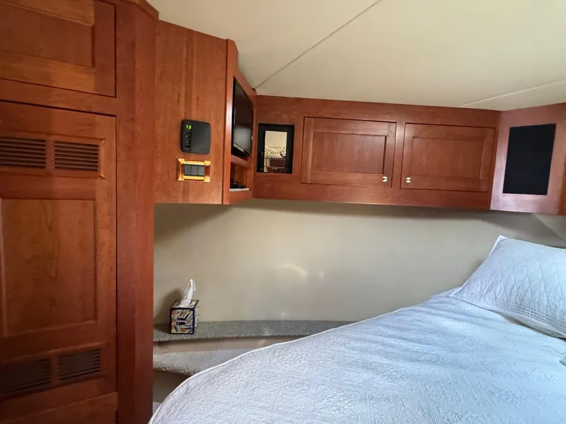 Slide: The Image of Interior cabin of a 2003 Rampage 45 Convertible with wooden cabinetry and a cozy bed. - 23