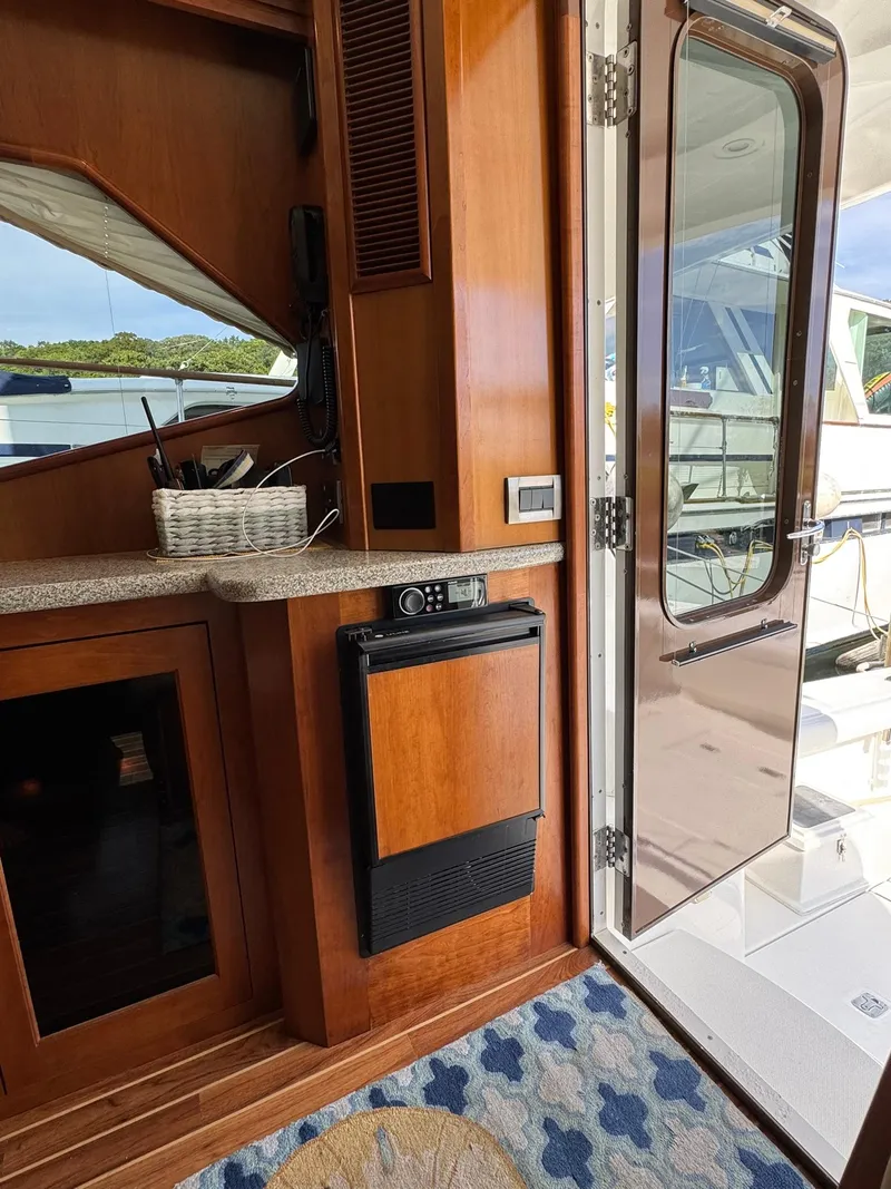 Slide: The Image of Interior view of 2003 Rampage 45 Convertible yacht with wooden cabinetry and open door. - 27
