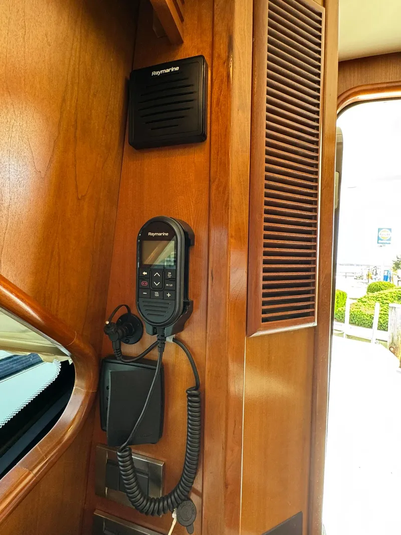 Slide: The Image of 2003 Rampage 45 Convertible interior with marine radio and wooden paneling. - 29