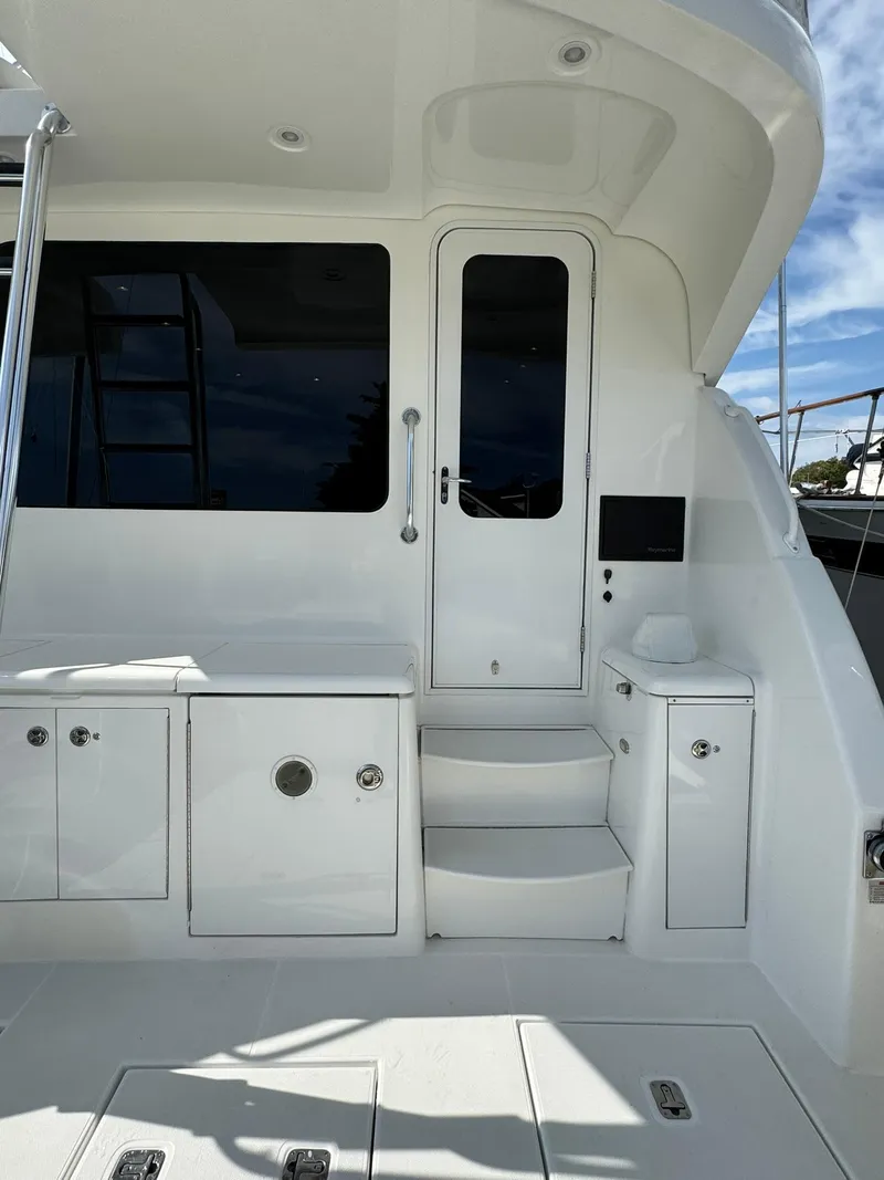 Slide: The Image of 2003 Rampage 45 Convertible yacht with sleek white exterior and modern design. - 32