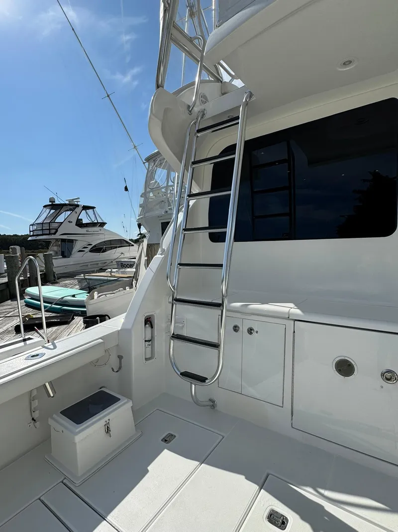 Slide: The Image of 2003 Rampage 45 Convertible yacht with ladder and deck, docked at marina. - 33