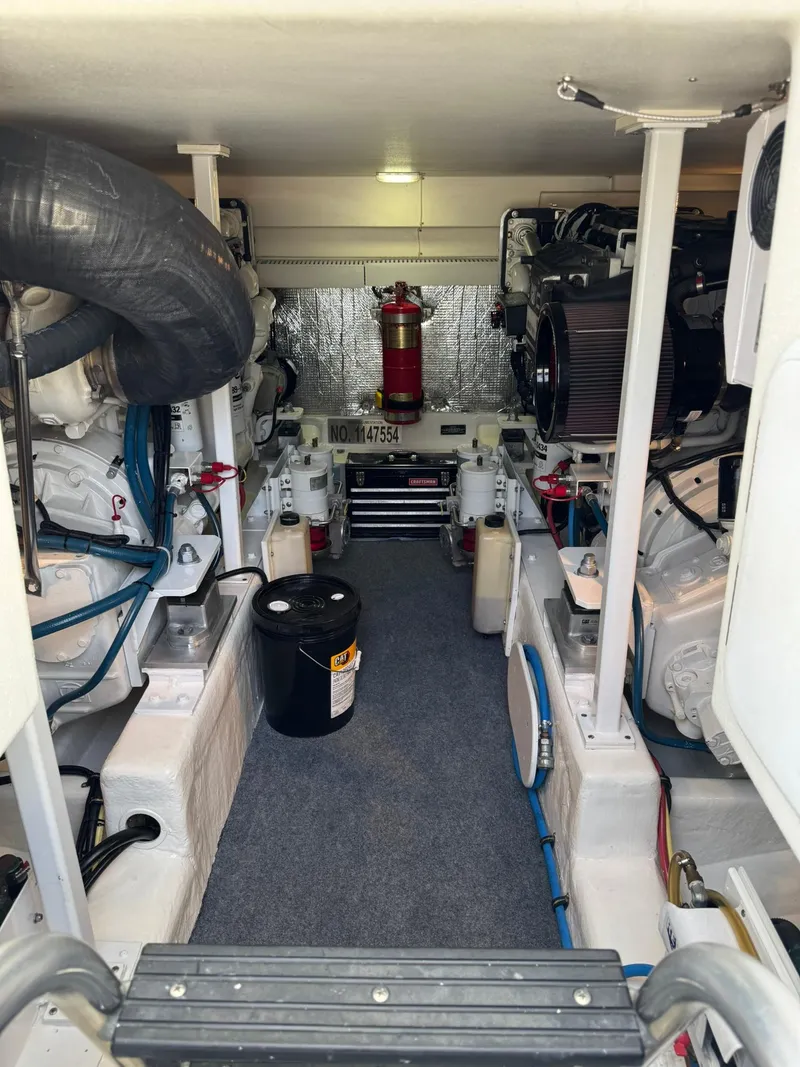 Slide: The Image of Engine room of a 2003 Rampage 45 Convertible boat, featuring mechanical components and equipment. - 46