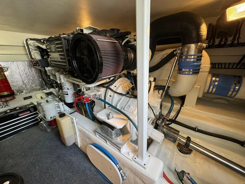 Slide: The Image of Engine room of a 2003 Rampage 45 Convertible boat, showcasing mechanical components and equipment. - 49