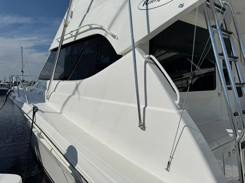 Slide: The Image of 2003 Rampage 45 Convertible yacht with sleek white exterior and modern design. - 7