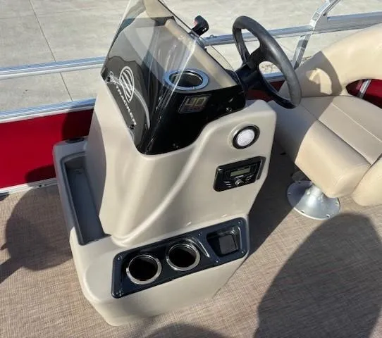 Slide: The Image of 2023 Sun Tracker Bass Buggy 18 DLX console with steering wheel and cup holders. - 12