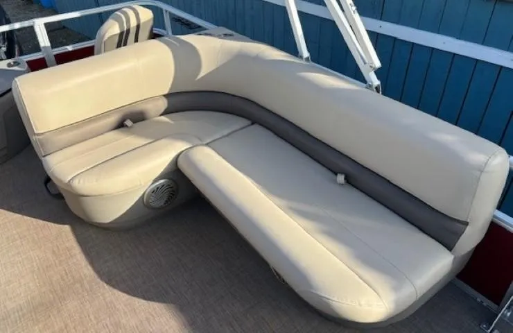 Slide: The Image of 2023 Sun Tracker Bass Buggy 18 DLX boat with beige seating and speaker. - 17